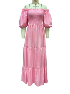 Detail of pink smocked bodice and tiered skirt on an off-shoulder floral maxi dress