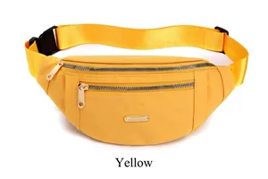 Detailed macro view of yellow water-resistant PU waist bag with gold metal dual zippers