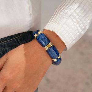 Detailed shot of dark blue glitter acrylic beads and gold spacers on a stretch bracelet