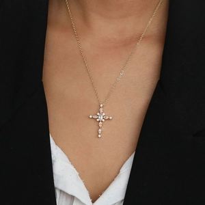 Close-up of 18k gold-plated cross pendant necklace featuring brilliant large zircon stones