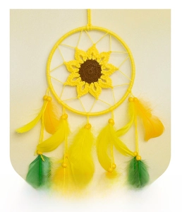 Close-up of handmade sunflower dreamcatcher with yellow feathers and woven cotton texture