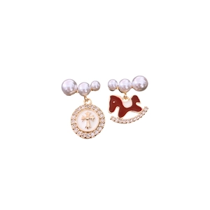 Asymmetric gold earrings with pearls, zircon ring, and red rocking horse pendant charms