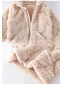 Detailed view of the smooth zipper and flat hem on a warm plush hooded baby coat