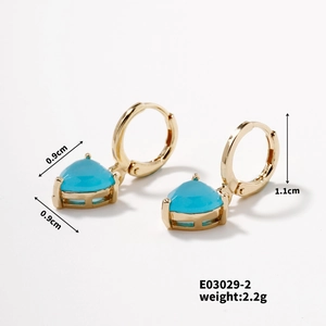 Detailed view of heart-shaped blue gemstone earrings with golden hoops and size specs