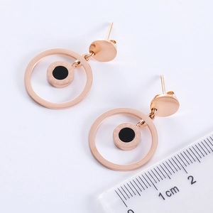 Exaggerated rose gold stainless steel hoop earrings with black Roman numeral discs