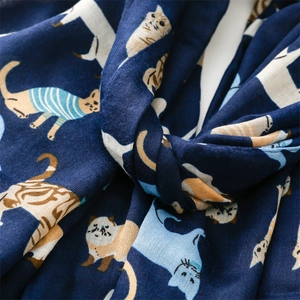 Detail of soft navy cotton linen scarf featuring colorful cartoon cat print texture