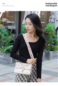 Close-up of sparkling sequin flap and heart-shaped metal lock on creamy crossbody bag