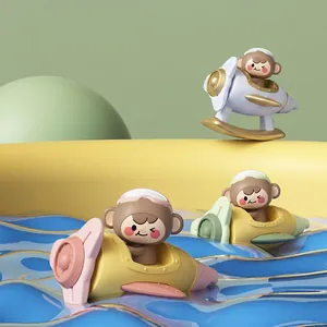 Three cute monkey airplane bath toys for babies with colorful designs on water