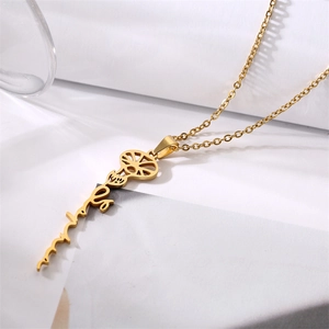 Close-up of gold stainless steel birth flower necklace with vertical script name pendant
