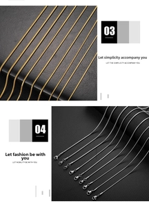 Detail of gold and silver snake bone necklaces with lobster clasps on black leather