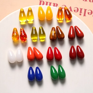 Macro view of colorful resin teardrop charms for DIY jewelry and hair accessories