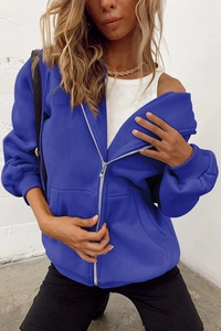 Close-up of blue oversized zip-up hoodie featuring front pockets and dropped shoulders