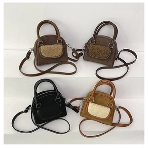 Detail view of four velvet-touch crossbody bags in coffee, brown, black and camel colors