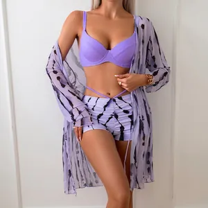 Three-piece purple bikini set with high waist tie-dye shorts and long sleeve mesh cover-up