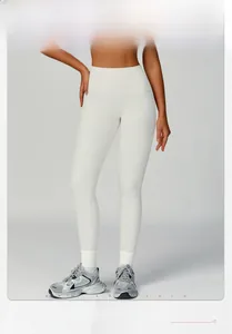 Detail of high waisted ribbed yoga leggings in cream white with premium vertical texture