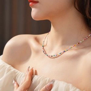 Close-up of a colorful beaded necklace on a model's neck for a trendy summer look