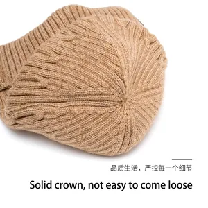 Close-up of thick khakis knitted beanie showing sturdy top stitching and warm texture