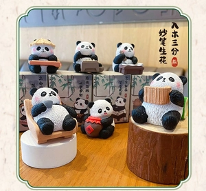 Detailed set of cute panda figurines with realistic fur texture on wooden desktop