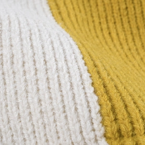 Women's two-tone knit beanie featuring yellow and white ribbed patterns and fuzzy texture