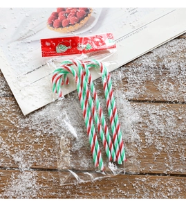 Close-up of candy cane Christmas ornaments with red, green and white spiral patterns