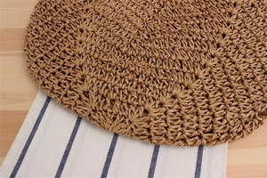 Macro view of woven paper rope shoulder bag showing intricate hollow weave patterns