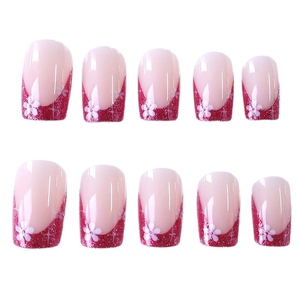 Pink French press-on nails with rose gold glitter, white flowers and star design