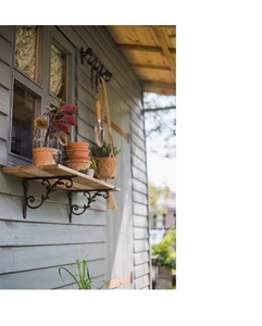 Close-up of vintage cast iron shelf brackets with ornate European vine patterns