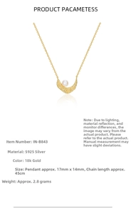 Detail of 18k gold S925 silver necklace with lava texture pendant and white pearl inlay