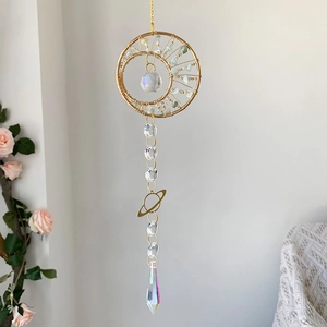 Macro view of crystal suncatcher featuring a golden crescent moon and faceted prism beads