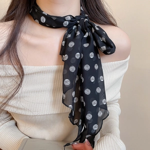 Close-up of black and white polka dot silk scarf necklace for an elegant fashion style