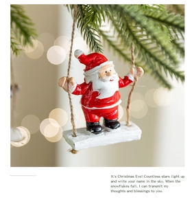 Close-up of a Santa Claus resin figurine on a wooden swing with natural hemp rope