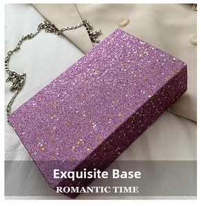 Detail of purple sequin box bag with gold star patterns and silver metal chain strap