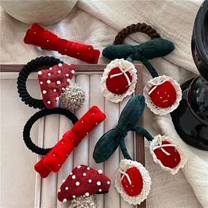 Cute red cherry hair clip and velvet bow scrunchie set for girls on a wooden tray