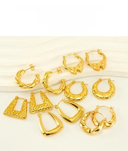 Flat lay of diverse 18K gold plated stainless steel geometric hoop and drop earrings