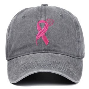 Close-up of pink ribbon embroidery on washed grey cotton adjustable baseball cap