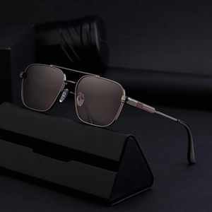 Detail of luxury polygon sunglasses with metal frame and double bridge on case