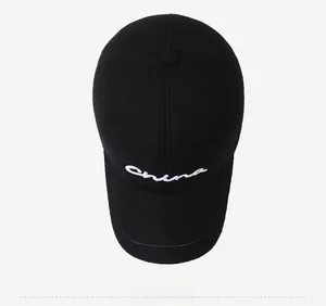 Top view of black cotton baseball cap with white China embroidery detail and top button