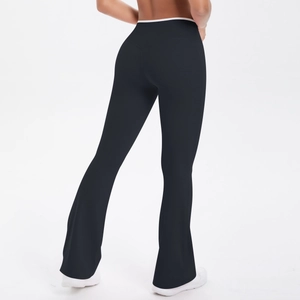 Detail showing the white contrast waist trim and high-waisted flare cut on black yoga pants