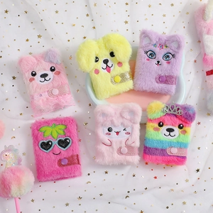 Detail of colorful plush mini notebooks with cartoon animal covers and snap closures