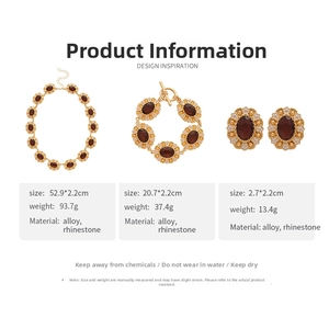 Detailed set of vintage gold necklace, bracelet and earrings with red oval gemstones