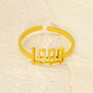 Macro detail of gothic style 1999 year number on adjustable gold plated steel ring