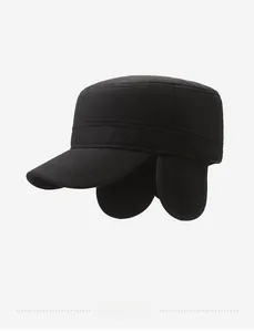 Detail of winter wool flat top cap with protective ear flaps and metal badge