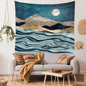 Detail view of large abstract wall tapestry with golden mountains and blue wave patterns