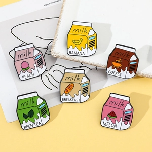 Close-up of cute cartoon milk carton enamel pins set with fruit and coffee themes