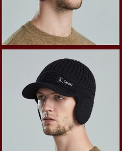Detailed view of the thick black knitted visor hat with Sport embroidery and ear protection