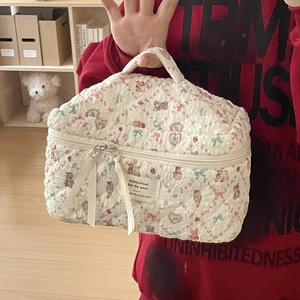 Quilted floral cosmetic bag with teddy bear prints and convenient top handle