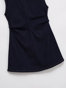 Detail of dark blue denim dress fabric texture and waist pleats on sleeveless style
