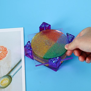 Macro view of colorful glitter patterns inside a resin coaster with purple geometric base
