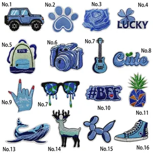 Macro detail of 16-piece blue embroidered patch set showing fine stitching and textures