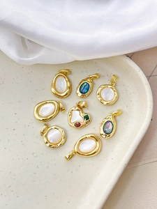 Detailed view of 18k gold-plated heart and shell pendants for DIY jewelry making